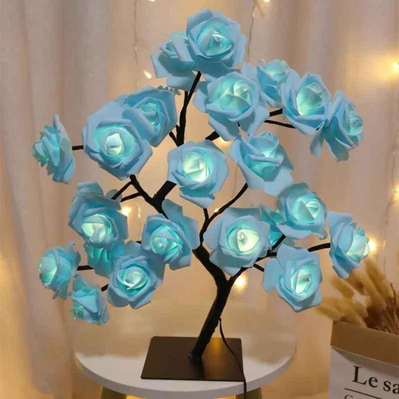 LED rose flower lamp with blue petals on a table, glowing against a curtain backdrop