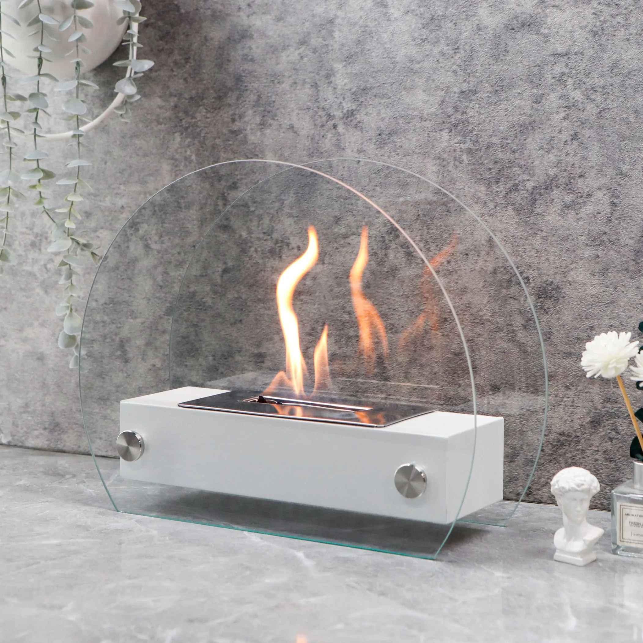 Modern tabletop bioethanol fireplace with glass shield on grey marble surface