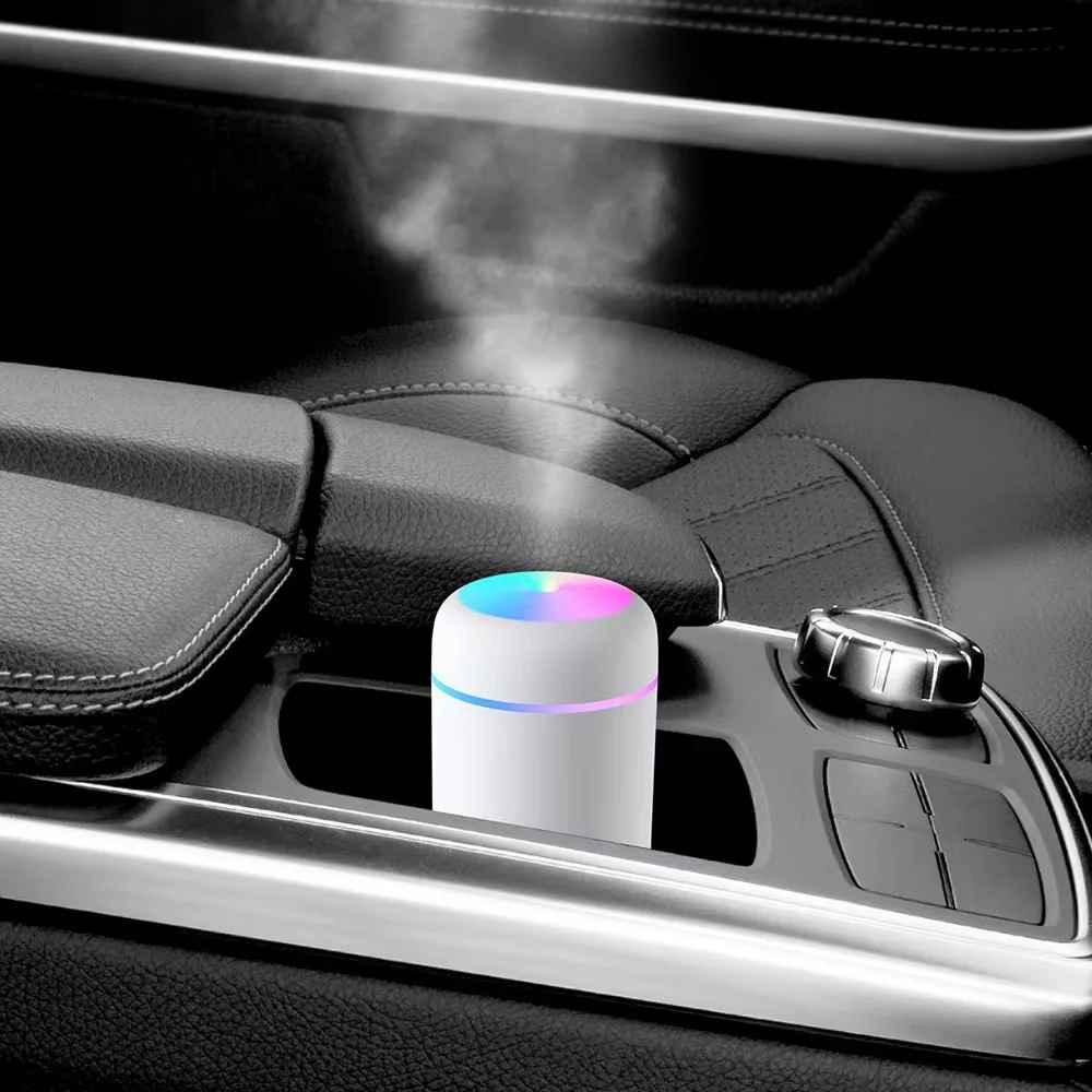 Portable car humidifier with LED light emitting mist in a black leather car interior