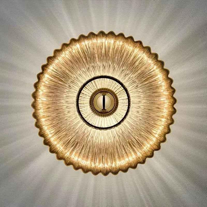 Radiant gold glass ceiling light fixture with sunburst design on white ceiling