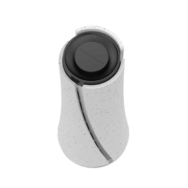 Modern white speckled portable speaker with black top and spiral design on a white background