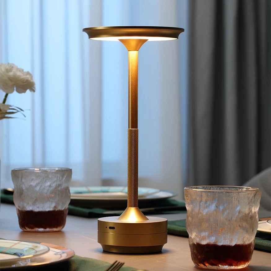 Modern gold LED table lamp on dining table with drinks and plates, elegant decor
