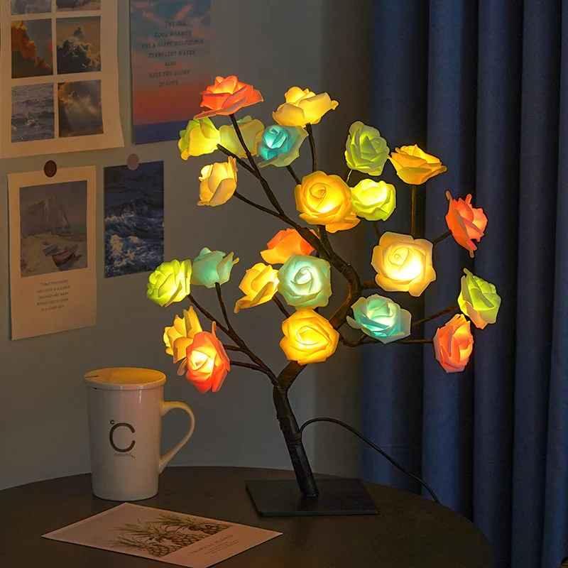 Colorful LED rose flower lamp on a table with a mug and wall art in cozy room
