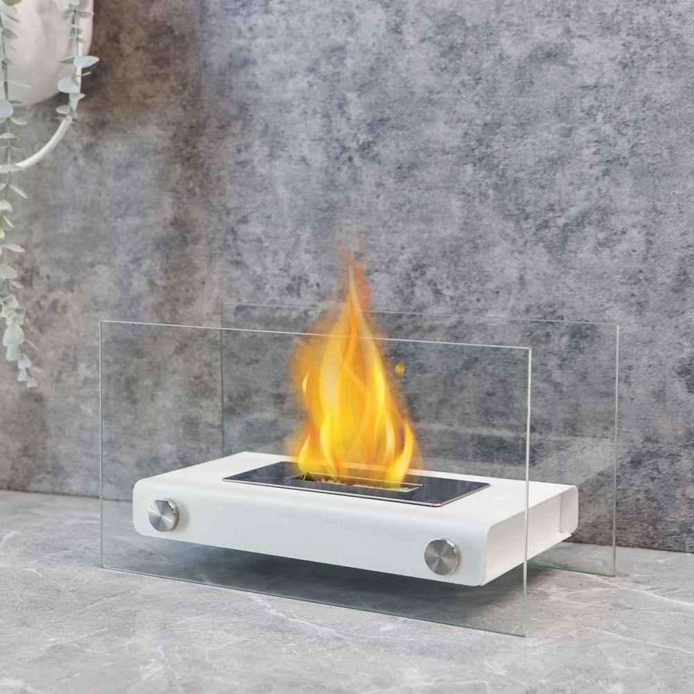 Modern tabletop bioethanol fireplace with glass sides on gray stone surface