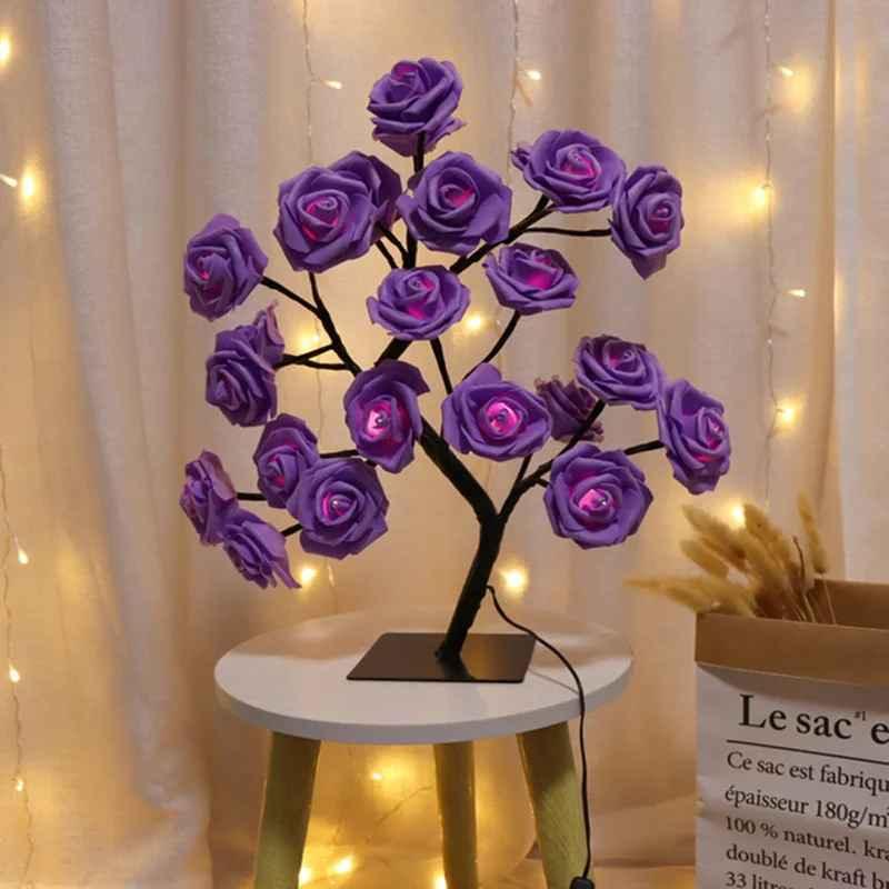 LED purple rose flower lamp on white table with fairy lights background
