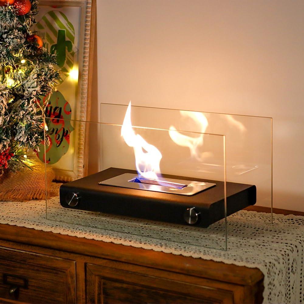 Tabletop bioethanol fireplace with glass shields on wooden sideboard, Christmas decor nearby.