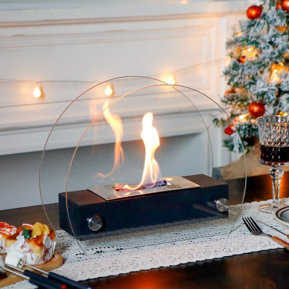 Tabletop indoor fireplace on dining table with holiday decor and Christmas tree