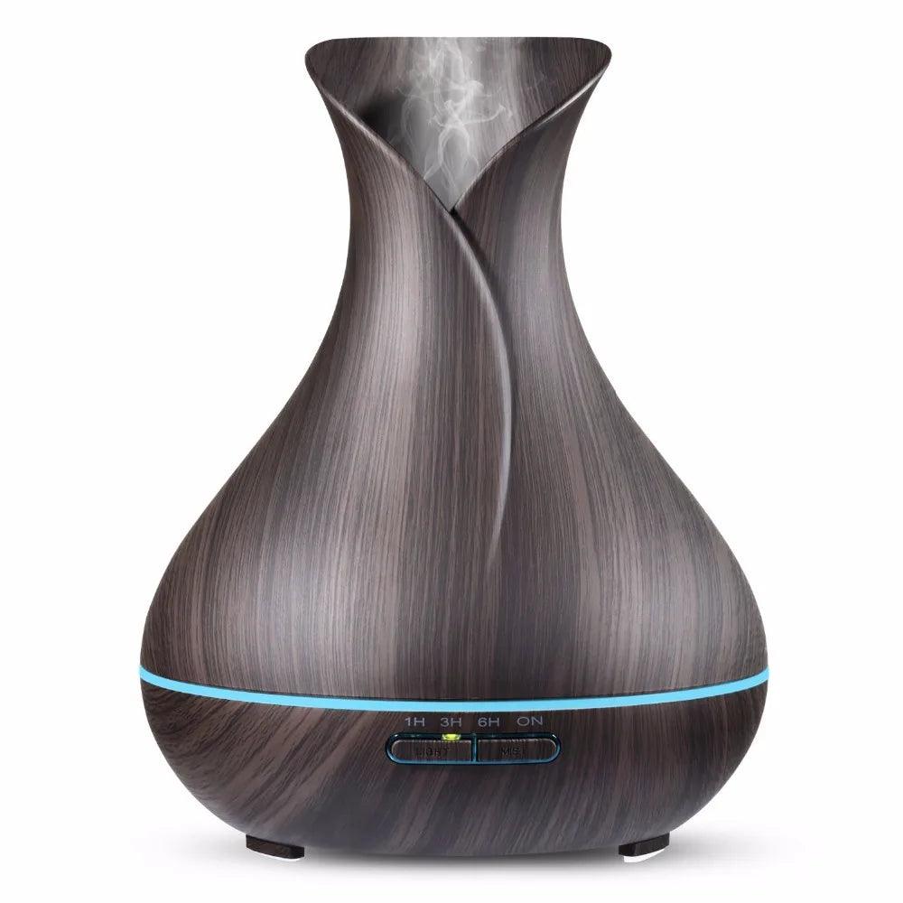 Modern dark wood grain essential oil diffuser with LED light and visible mist output, tabletop