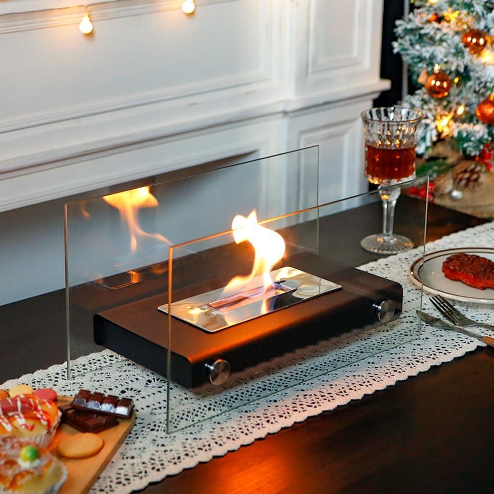Tabletop glass bioethanol fireplace on dining table with Christmas decor and wine