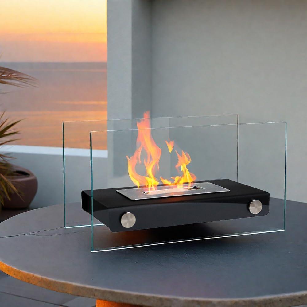 Modern tabletop glass-encased fire pit on patio at sunset with ocean view