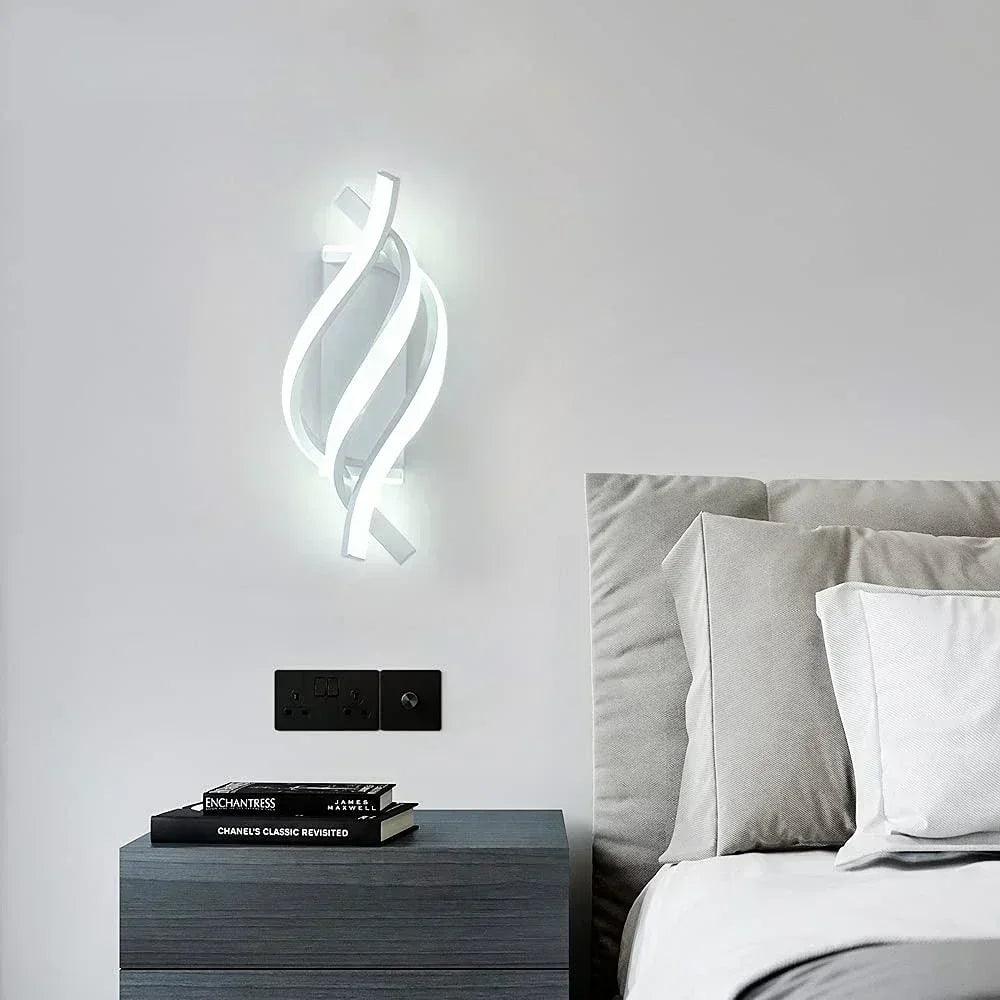 Modern LED wall light above bedside table in minimalist bedroom with gray bedding