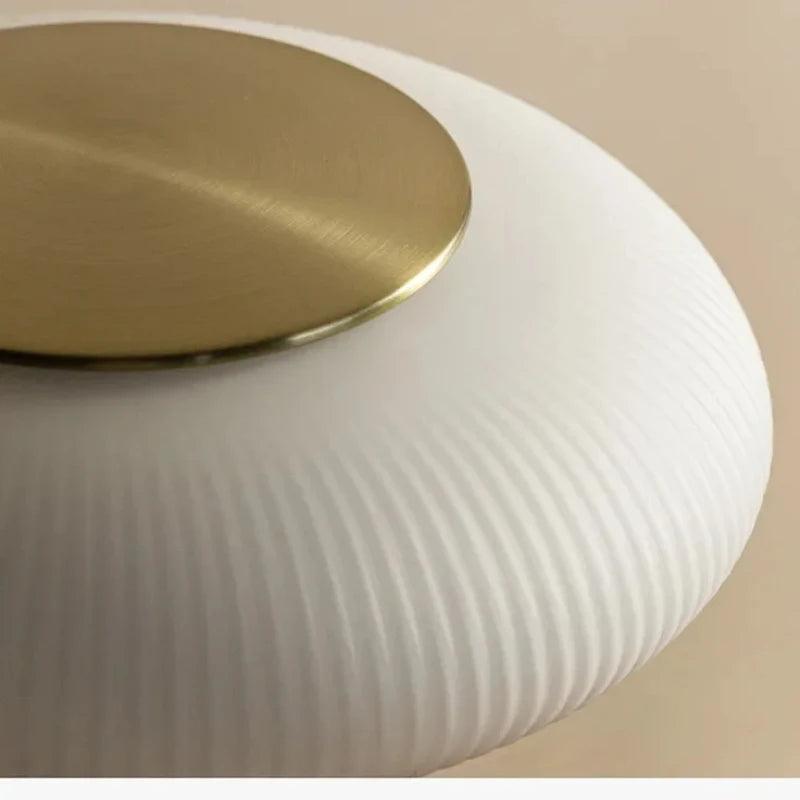 Modern white ribbed glass lamp shade with a round brass accent on top