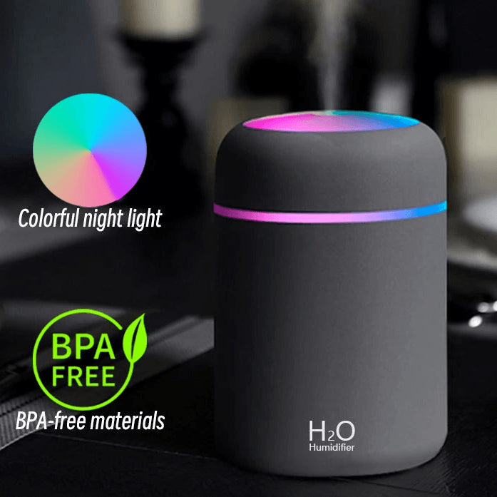 Black H2O humidifier with colorful night light, BPA-free, on a table indoors