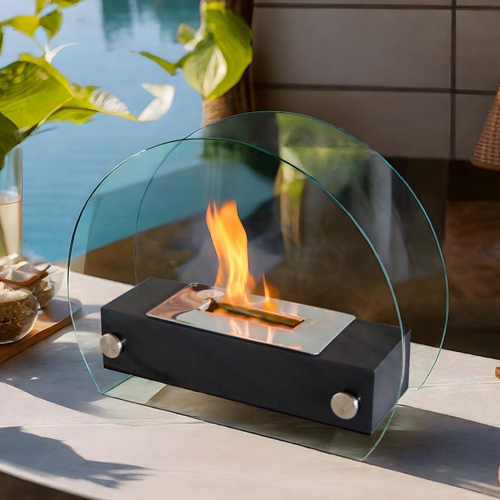 Modern tabletop glass fireplace with flame on outdoor patio by a pool