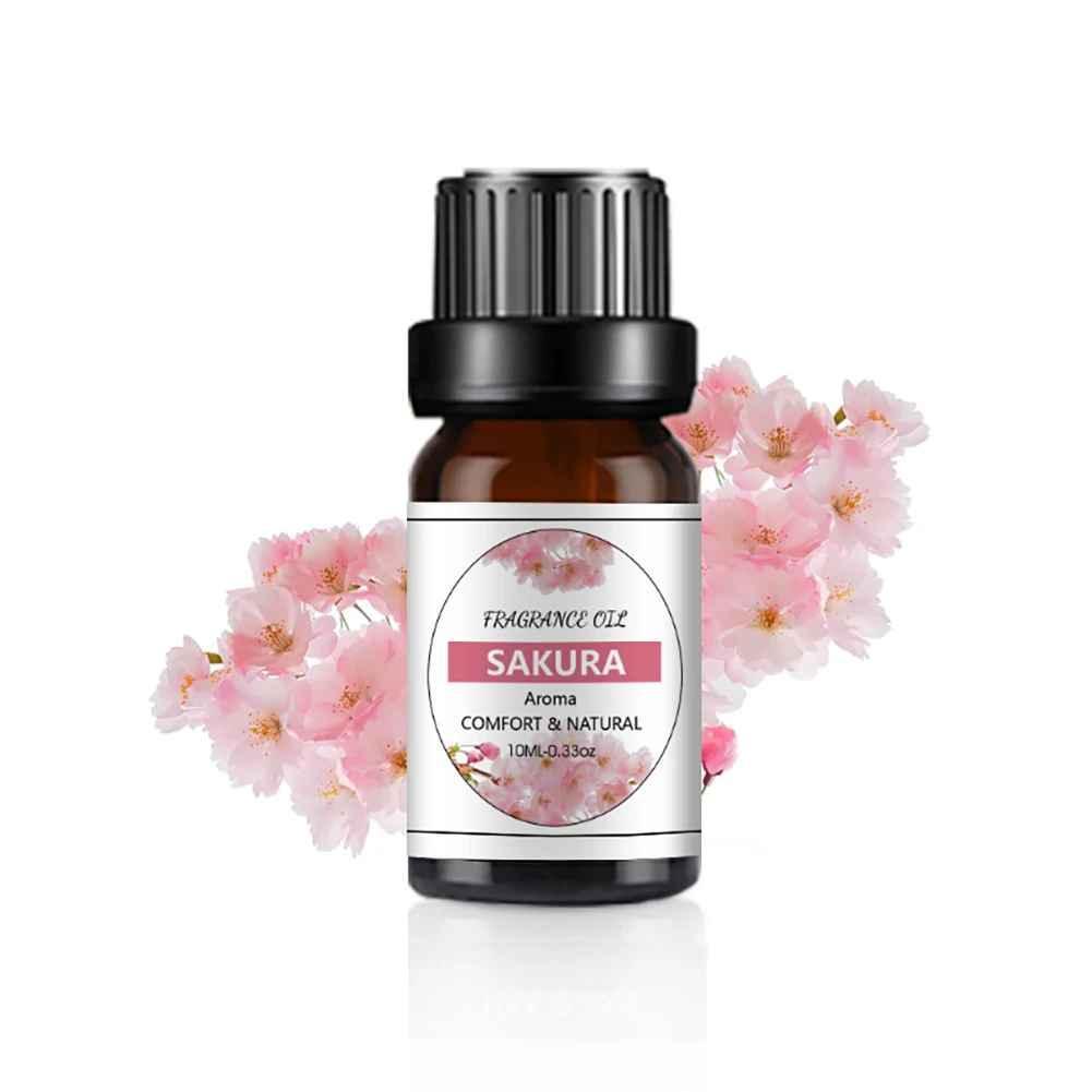Bottle of Sakura fragrance oil with cherry blossom flowers on a white background