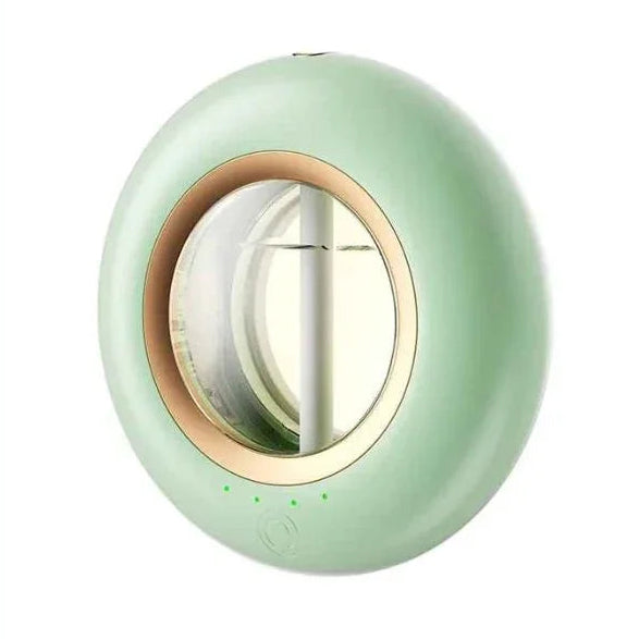 Green round essential oil diffuser with gold trim on a white background