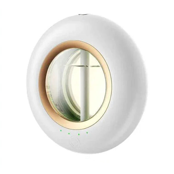 Modern white essential oil diffuser with gold trim on a light background