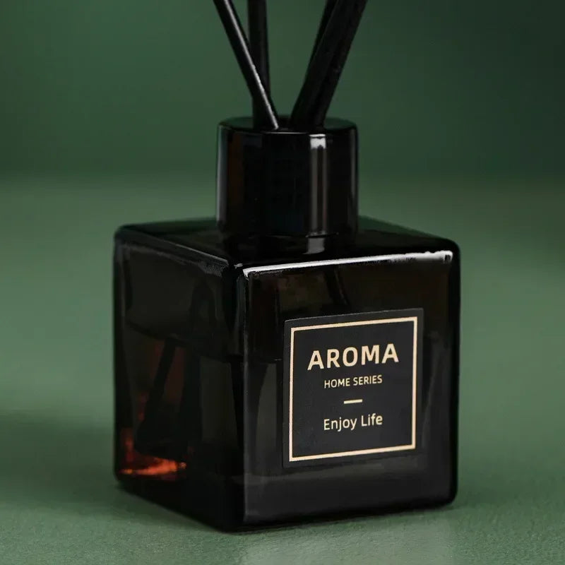 Black Aroma home series diffuser with 'Enjoy Life' on a green background